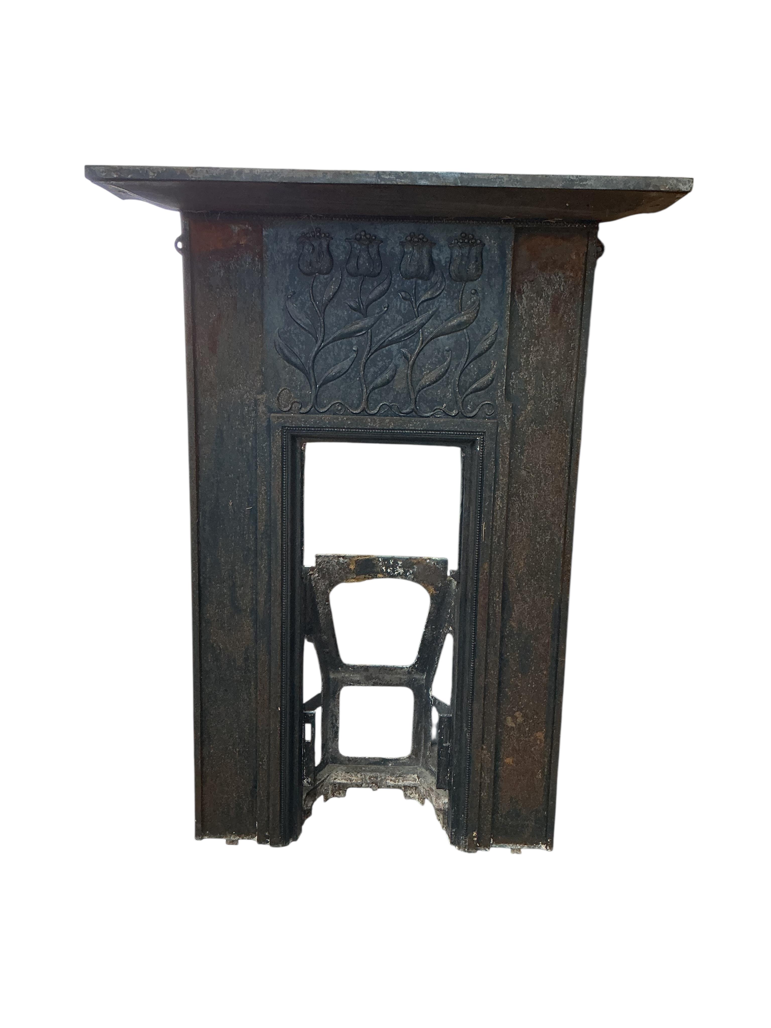 A late Victorian Art Nouveau cast iron fire surround, with tulip design, width 94cm, height 126cm